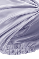 Purple silk sleep cap for women by MANITO, featuring a blooming floral design, designed to protect hair during sleep.