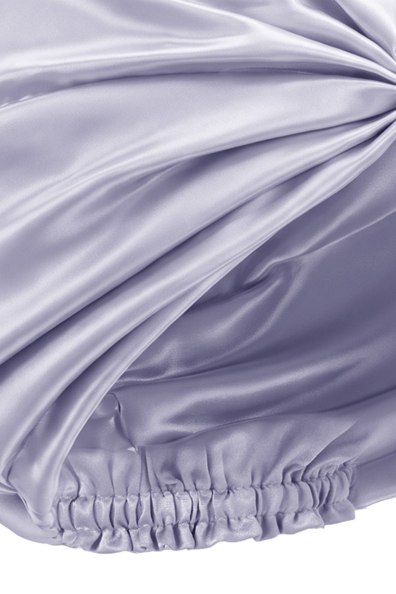 Purple silk sleep cap for women by MANITO, featuring a blooming floral design, designed to protect hair during sleep.
