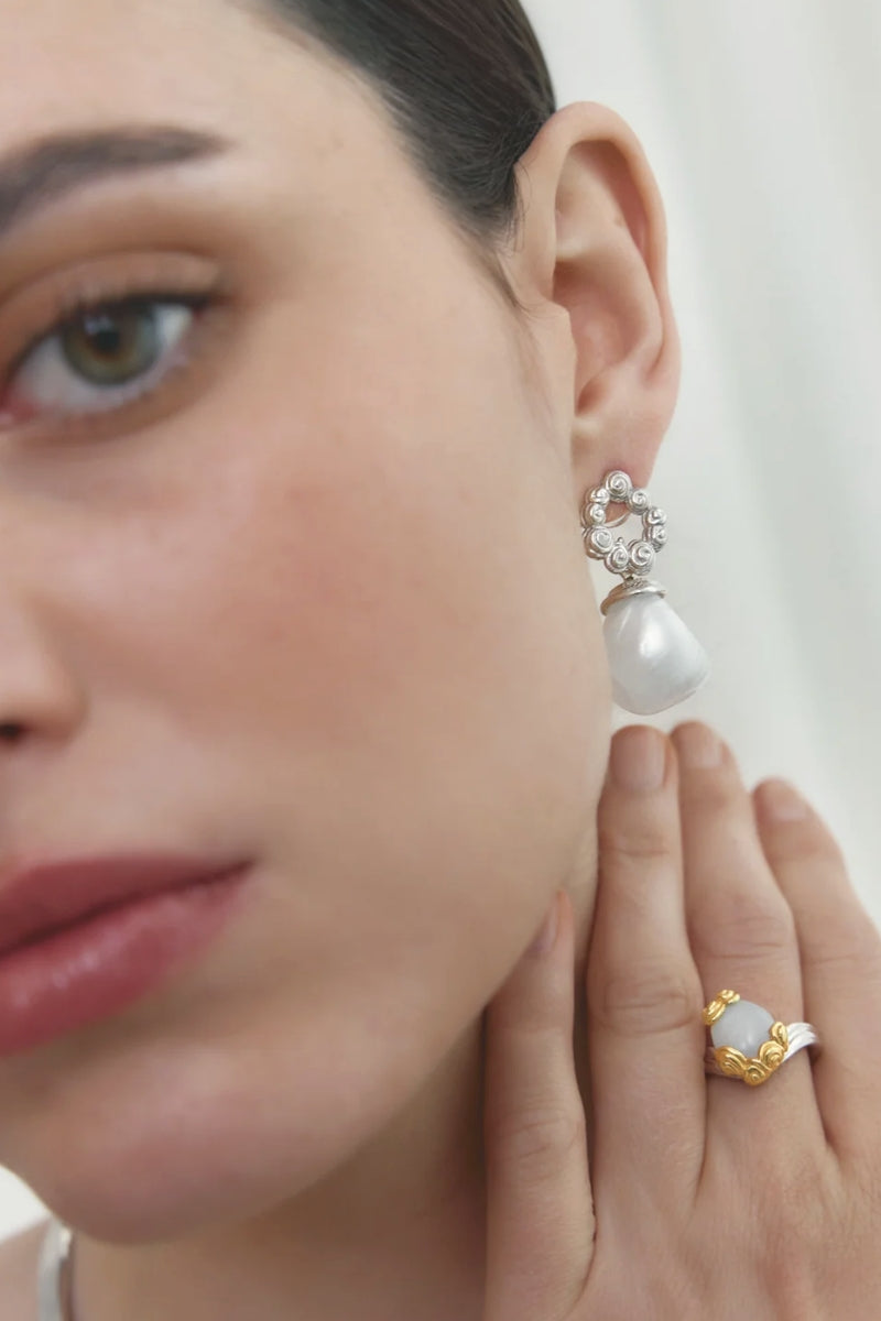 Elegant Bloom Ring by Jude Benhalim featuring a delicate floral design and polished silver finish.