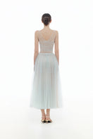 Blue V-neck draped midi dress by Montsand, showcasing a flowing fabric and elegant V-neck design on a stylish dress.
