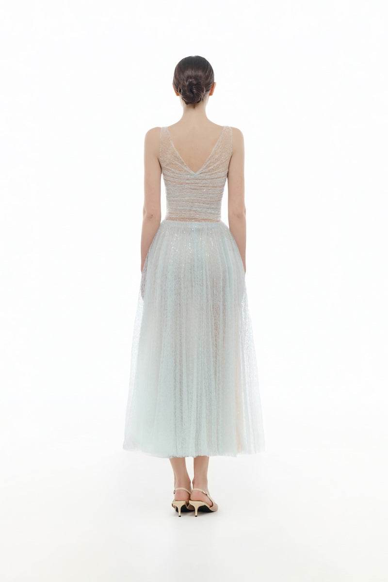 Blue V-neck draped midi dress by Montsand, showcasing a flowing fabric and elegant V-neck design on a stylish dress.