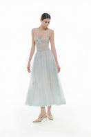 Blue V-neck draped midi dress by Montsand, featuring a flowing silhouette and elegant draping fabric.