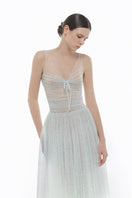 Blue V-neck draped midi dress by Montsand featuring a flowing silhouette and elegant design on a plain background.