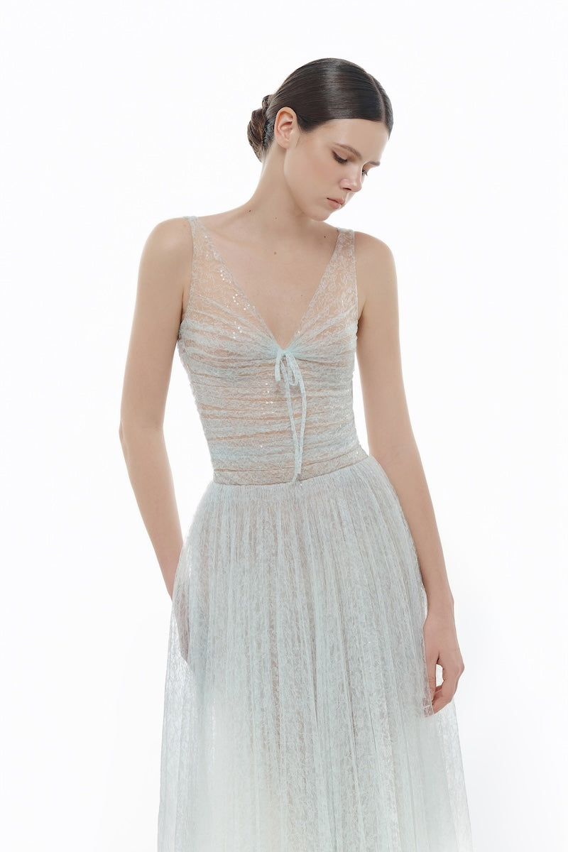 Blue V-neck draped midi dress by Montsand featuring a flowing silhouette and elegant design on a plain background.