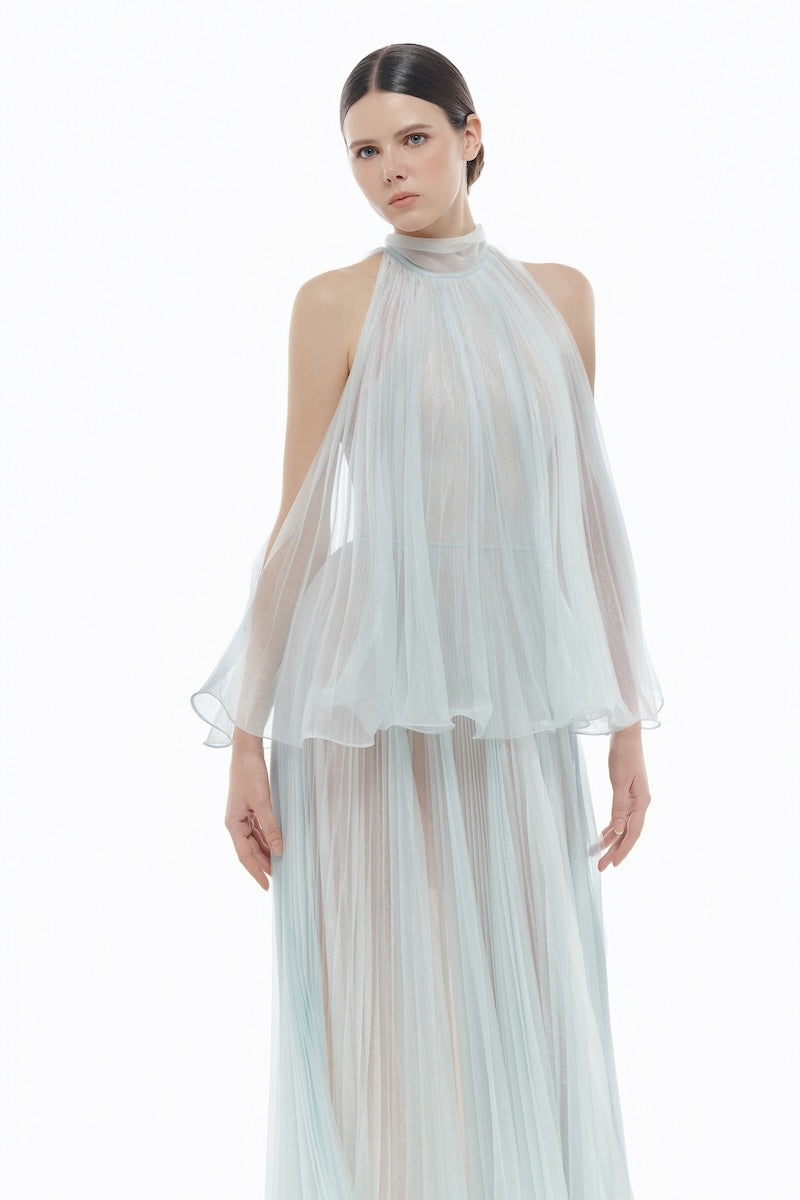 Blue pleated gown from Montsand featuring a midi length design, flowing fabric, and elegant style perfect for formal occasions.