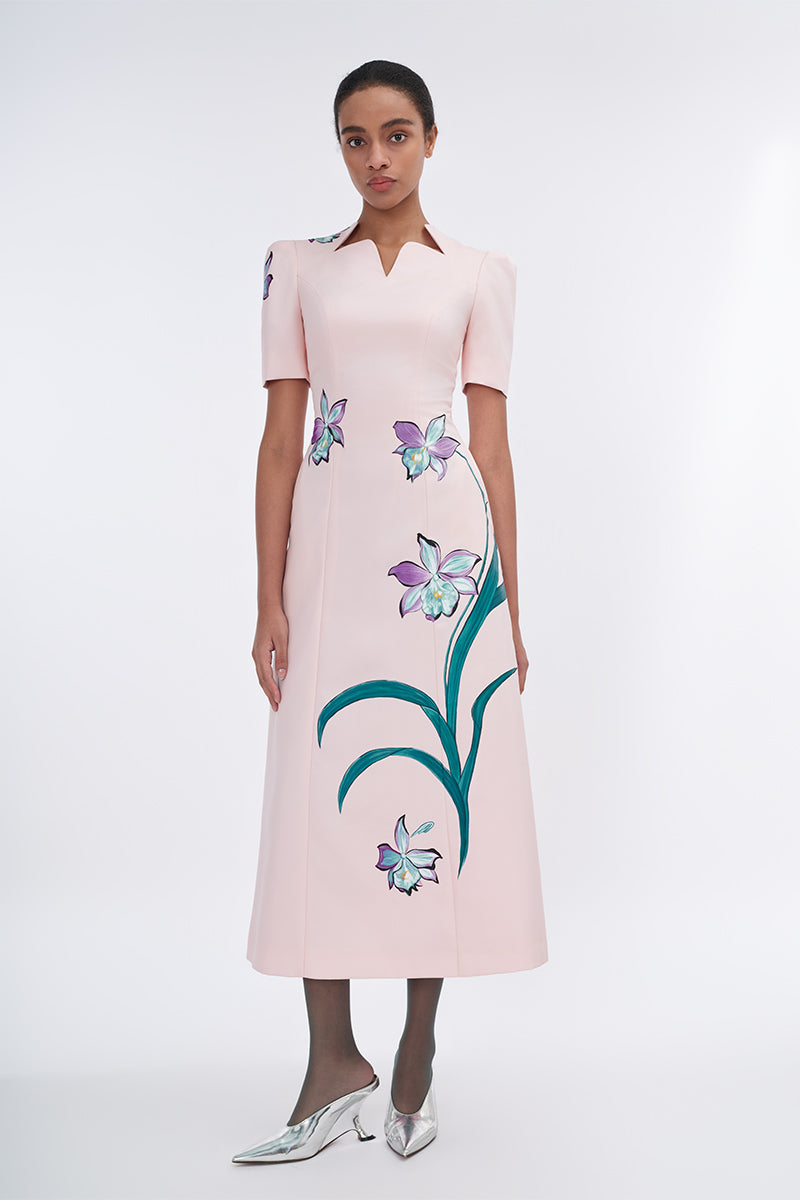 Blush sculpted notched A-line midi dress by Tiny Ink, featuring a fitted bodice and flowing skirt, shown from the side view.