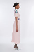 Blush sculpted notched A-line midi dress by Tiny Ink, featuring a fitted bodice and flowing skirt, styled for elegant occasions.