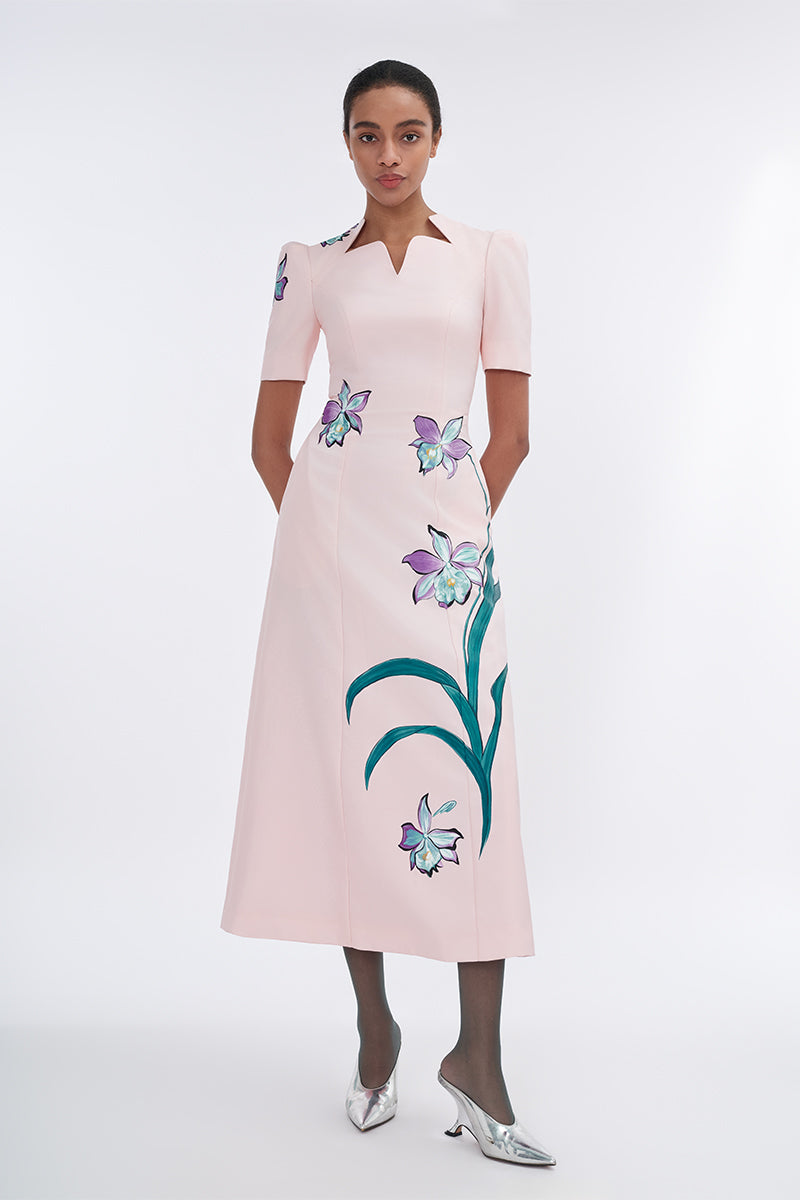 Blush sculpted notched A-line midi dress by Tiny Ink, featuring a fitted waist and stylish silhouette, shown on a model.