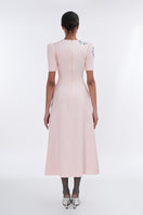 Blush sculpted notched A-line midi dress by Tiny Ink, featuring a fitted bodice and flared skirt with notch details.