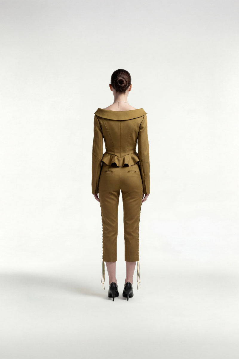 Green boat-neck boned jacket by Tayfun Kaba featuring structured design and detailed boning, stylish for modern fashion.