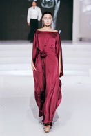 Red Valenciani boat neck flower ruched maxi dress showcased on the runway, featuring elegant floral details and flowing fabric.