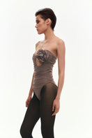 Brown draped bustier bodysuit by Kris Marán with a flower applique, featuring a fitted top and elegant design.