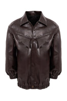 Brown oversized bomber jacket by KRIS MARÁN, shown hanging with front view and ribbed collar and cuffs.