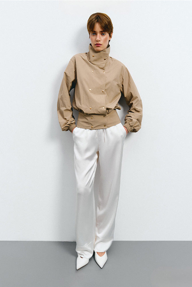 Kris Marán beige bomber jacket with high neck, stylish outerwear featuring a fitted design and ribbed cuffs.