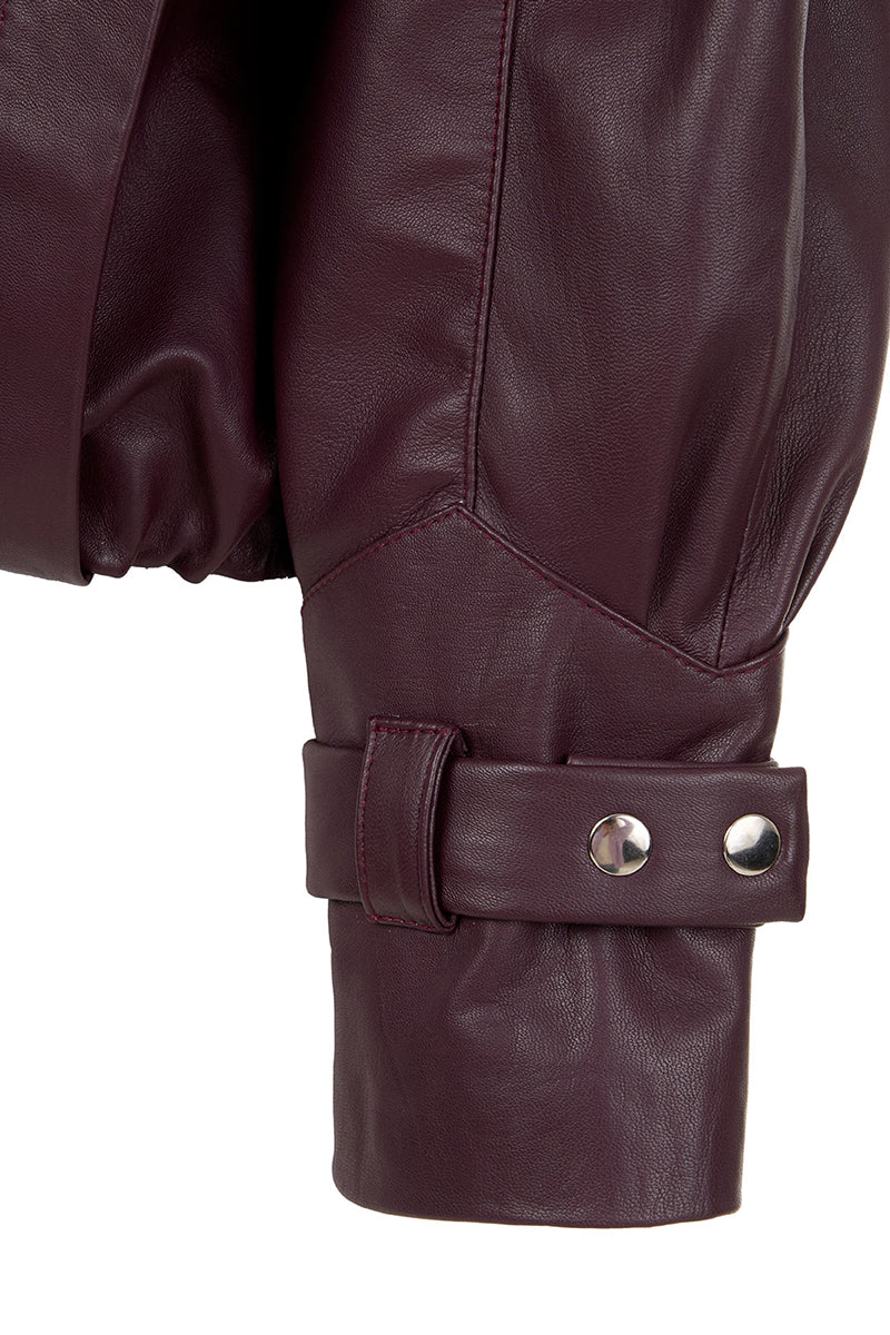 Wine red MAZ Manuela Álvarez leather bomber jacket, stylish and fitted, with ribbed cuffs and collar, shown on a model.
