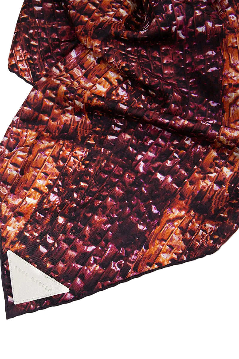 Elegant Bordeaux silk scarf by Amel Batita, featuring detailed weaving and vibrant color, perfect for stylish accessories.