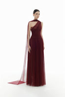 Elegant Bordeaux draped gown by Montsand, featuring flowing fabric and sophisticated design, perfect for formal occasions.