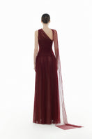 Elegant Bordeaux draped gown by Montsand featuring flowing fabric and sophisticated design, perfect for formal occasions.
