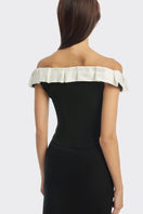 Black bow corset maxi gown by Stolen Stores featuring a structured bustier design and elegant flowing skirt.