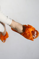Orange patent bow mules from House of Atana, stylish slip-on sandals with a decorative bow detail.