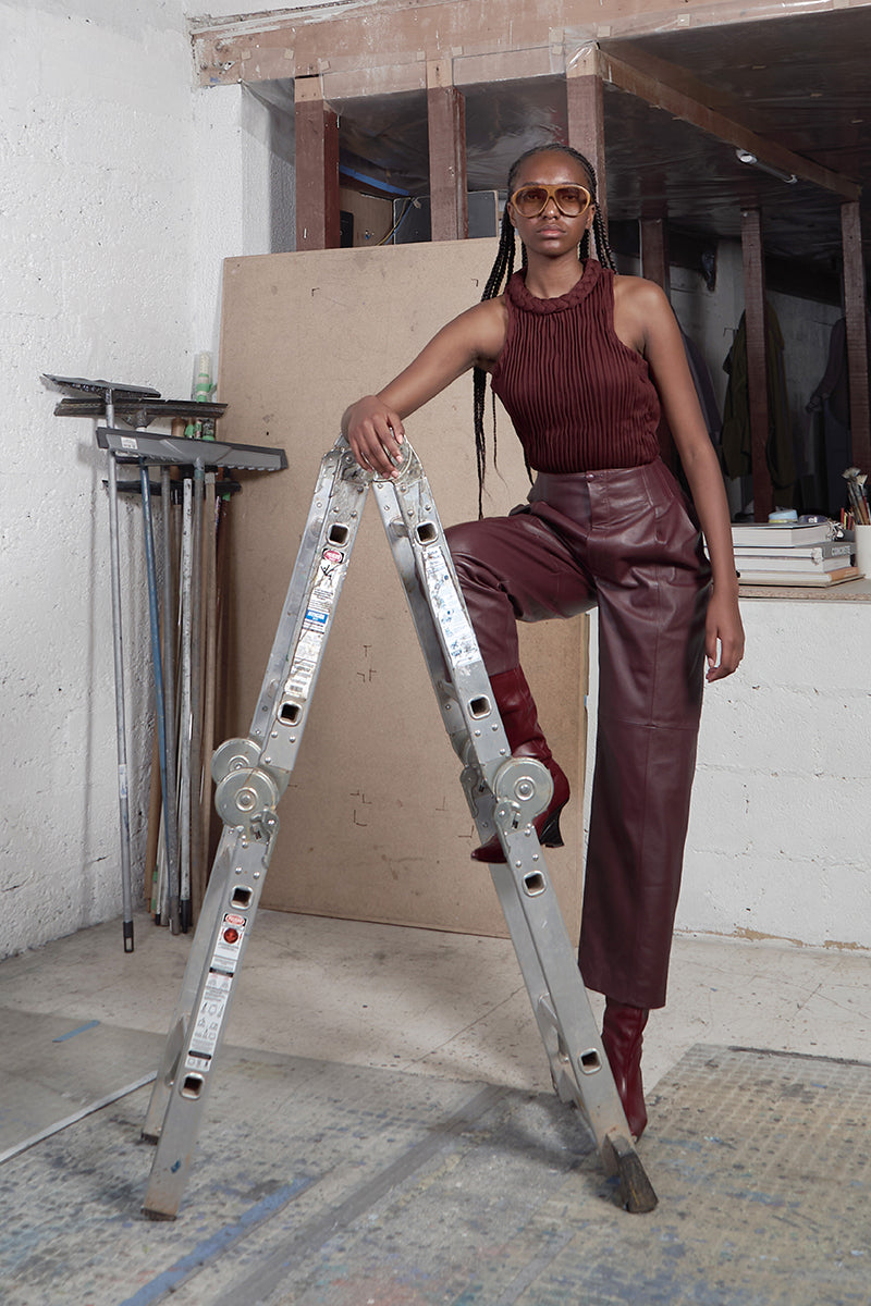 Wine red braided furrows top by MAZ Manuela Álvarez, stylish shirt with braided details, shown on a mannequin.