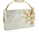 Blue Emm Kuo Brancuse clutch bag with sleek design and textured surface, shown in a close-up image.