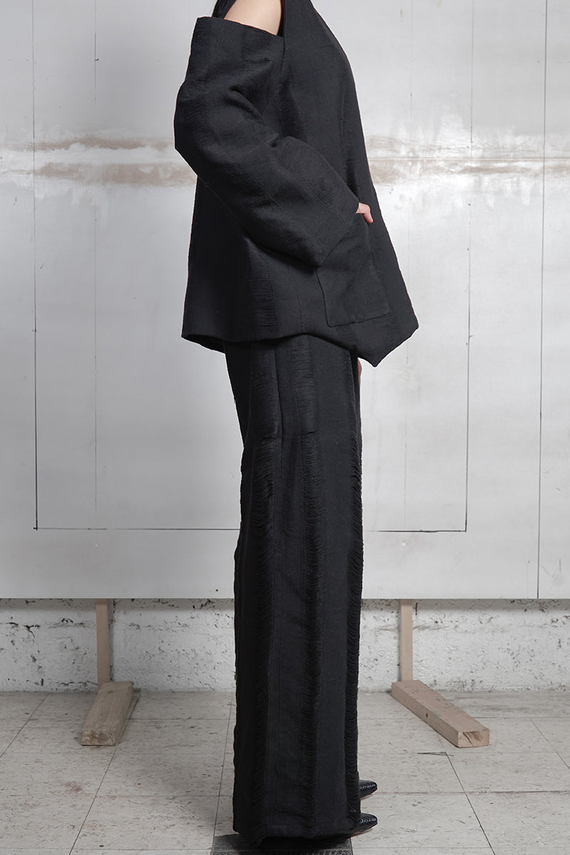 Black Bridge Weave blazer pants by MAZ Manuela Álvarez featuring tailored fit and woven fabric detail.
