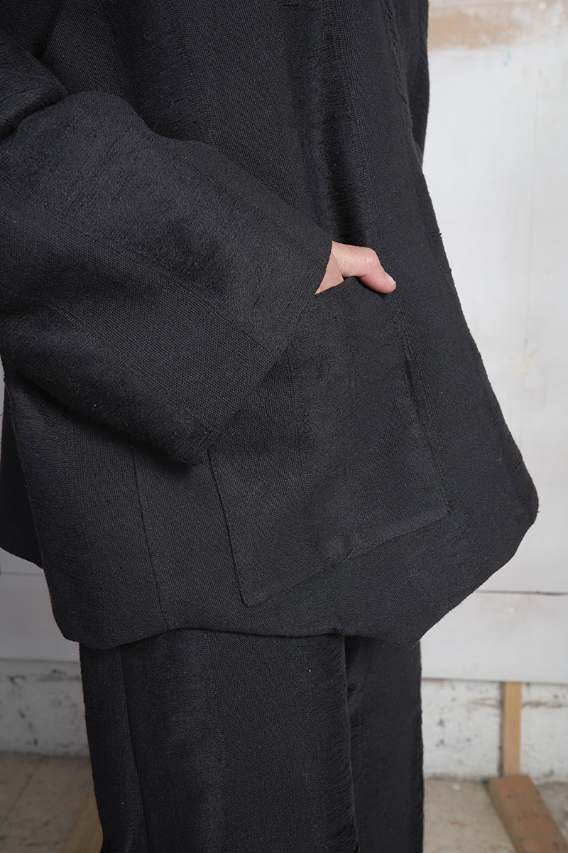Black Bridge Weave blazer pants by MAZ Manuela Álvarez, featuring tailored fit and stylish fabric weave detail.