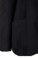 Black Bridge Weave blazer suit by MAZ Manuela Álvarez, tailored fit, showing the textured fabric and classic lapel design.