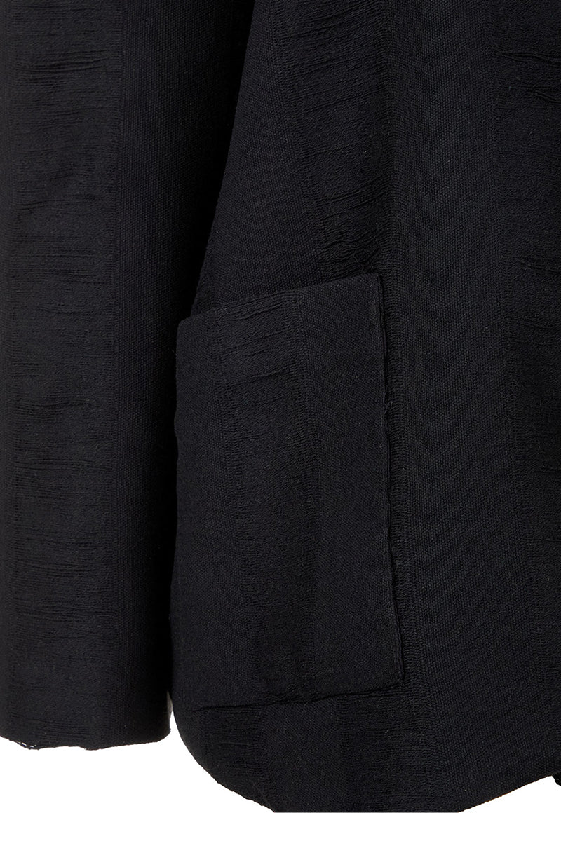 Black Bridge Weave blazer suit by MAZ Manuela Álvarez, tailored fit, showing the textured fabric and classic lapel design.