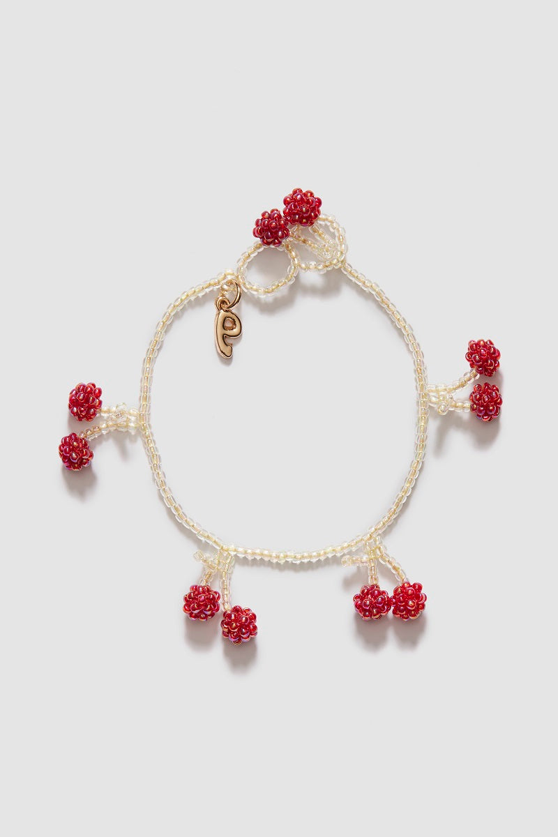 Bright cherry-colored bracelet by Pura Utz featuring vibrant beads and a stylish design for casual wear.
