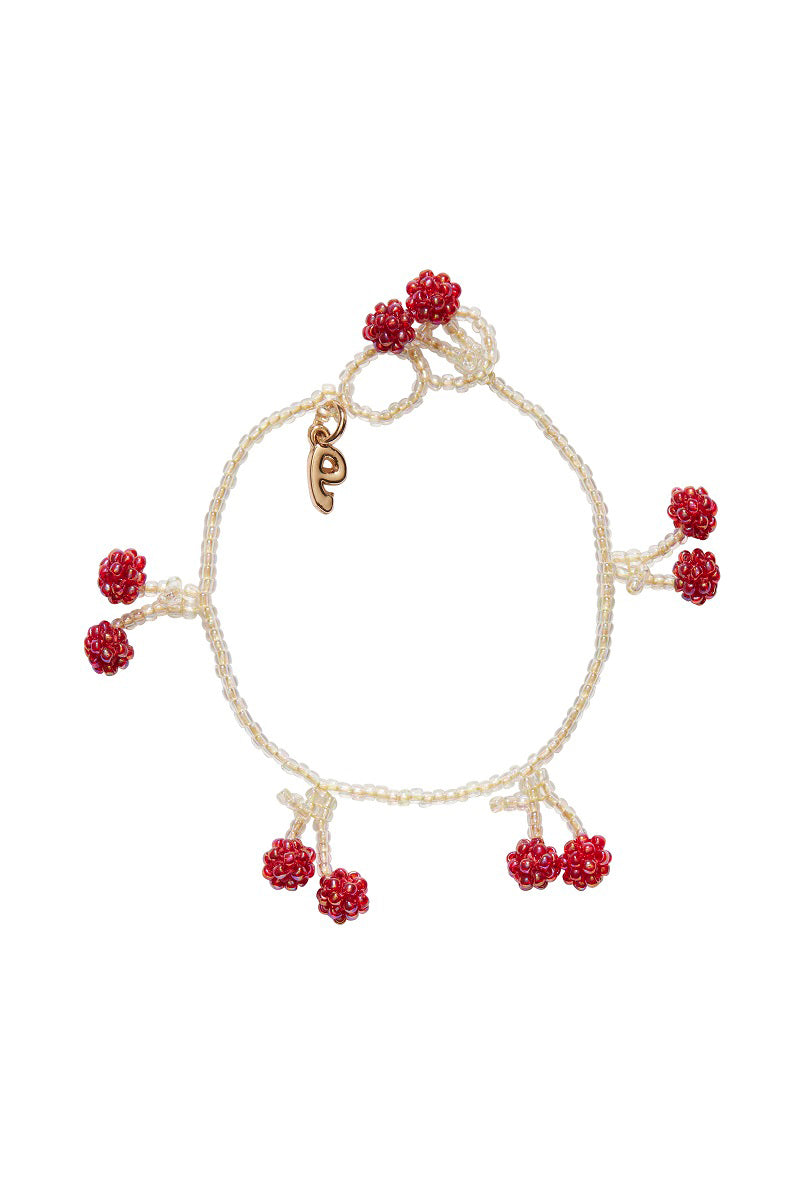 Bright cherry-colored bracelet by Pura Utz featuring vibrant beads and a sleek, stylish design.