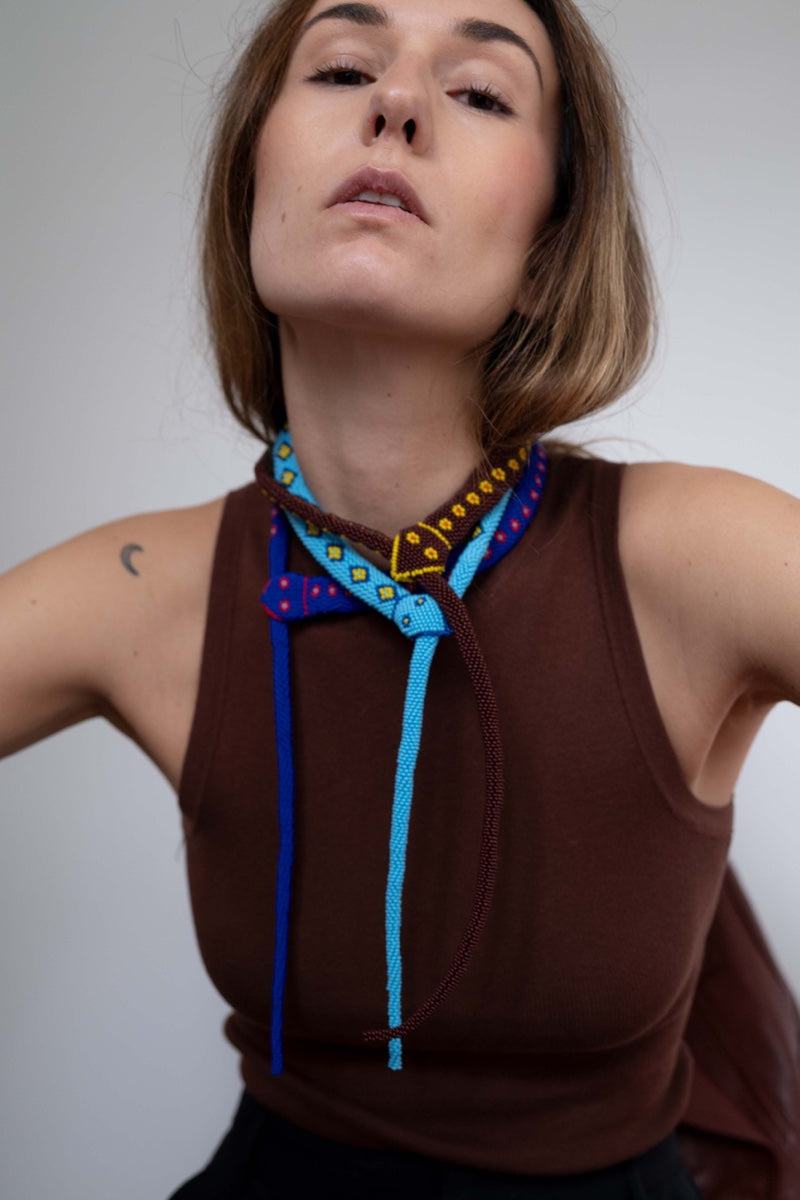 Light blue guardian snake necklace by Pájara Pinta featuring a detailed snake pendant on a chain.