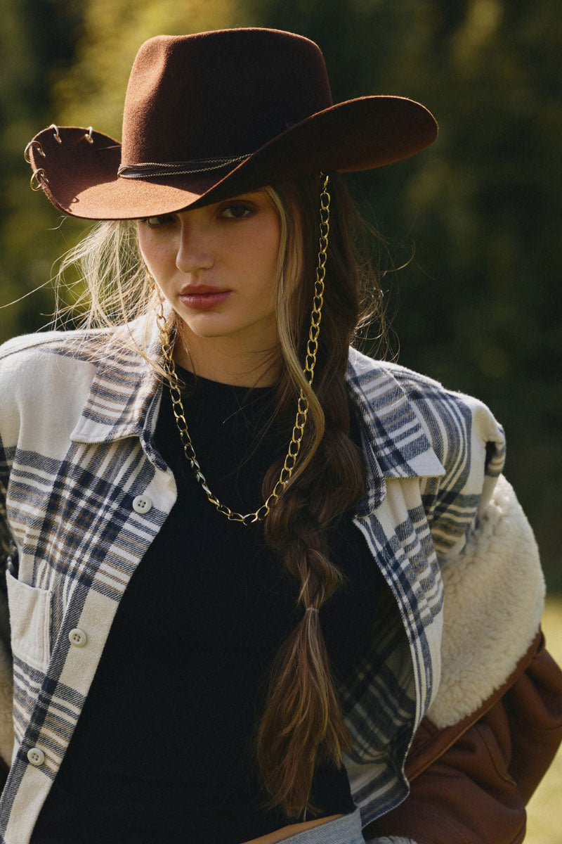 Brown cowboy hat by LE SH KA, featuring a wide brim and classic Western style, shown on a mannequin.