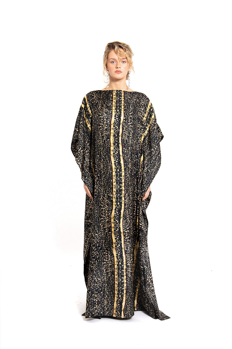 Brown Brocot kaftan maxi dress by Amel Batita featuring flowing fabric and intricate detailing, displayed on a hanger.