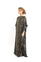Brown Brocot kaftan maxi dress by Amel Batita featuring flowing fabric and intricate brocot pattern, worn by a model.