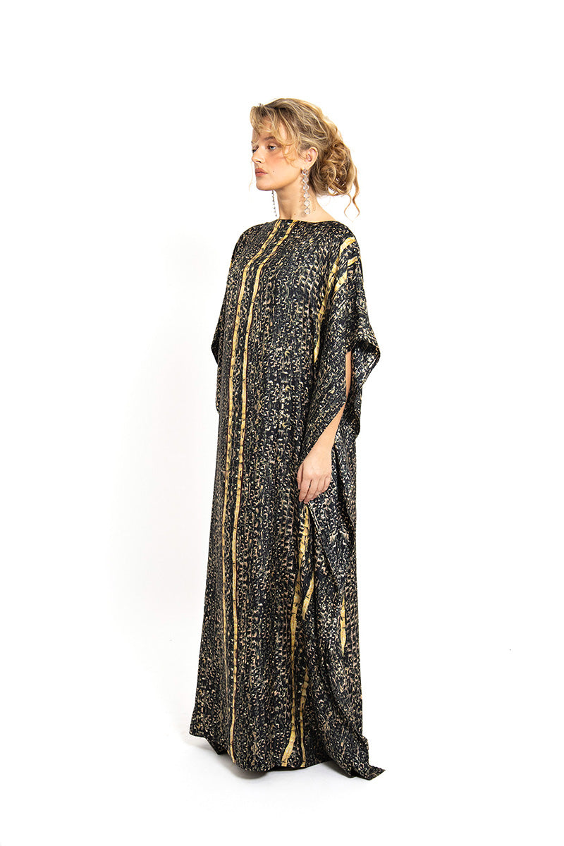 Brown Brocot kaftan maxi dress by Amel Batita featuring flowing fabric and intricate brocot pattern, worn by a model.