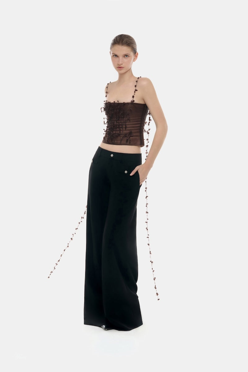 Brown 3D floral strap top by Montsand, featuring textured fabric and thin shoulder straps, showcased on a model.