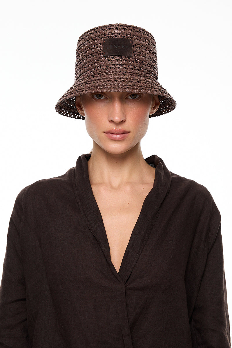 Brown bucket hat by LE SH KA featuring a casual, wide-brim design in soft brown fabric.