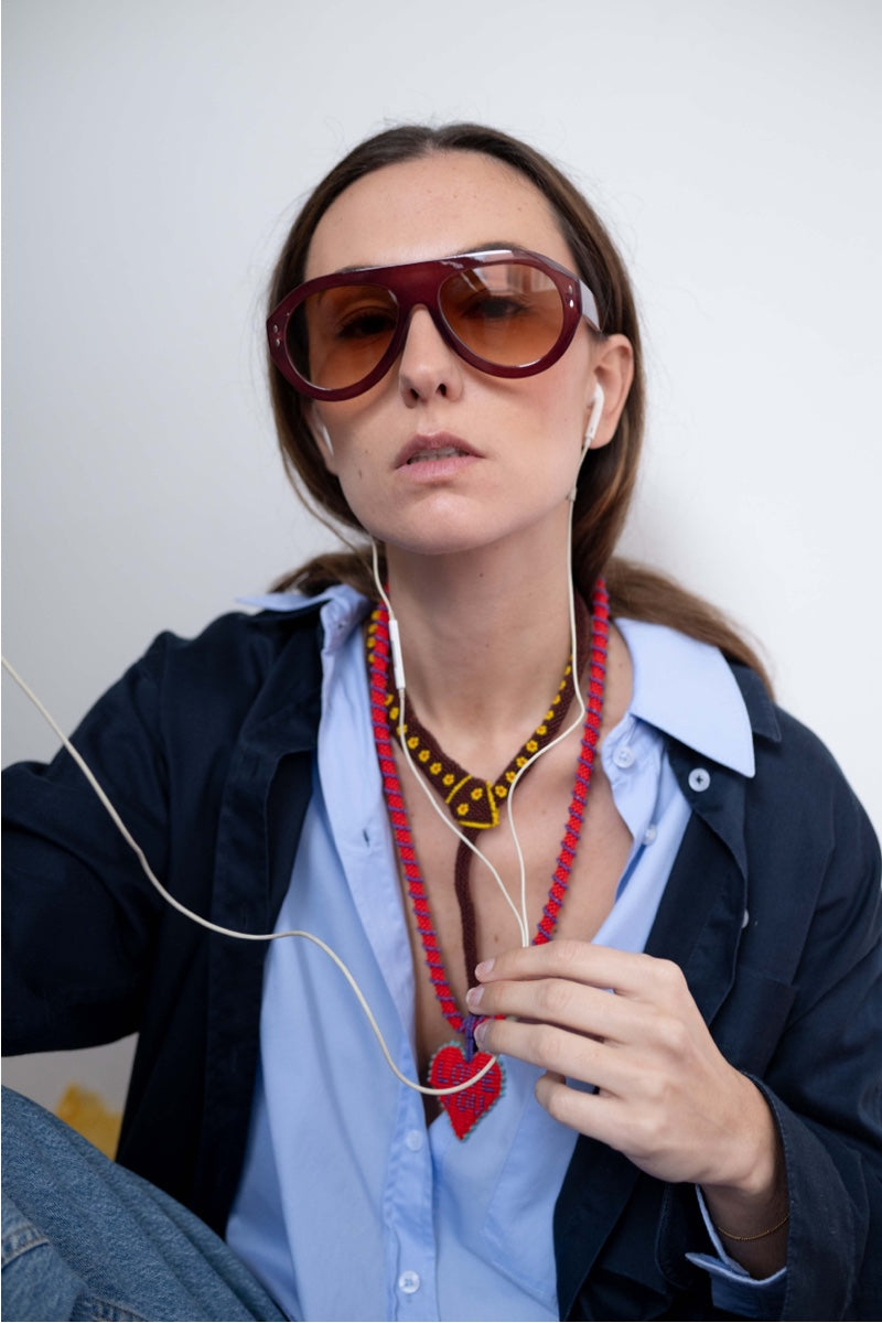 Brown Guardian Snake Necklace by Pájara Pinta featuring a sleek snake design on a brown pendant.