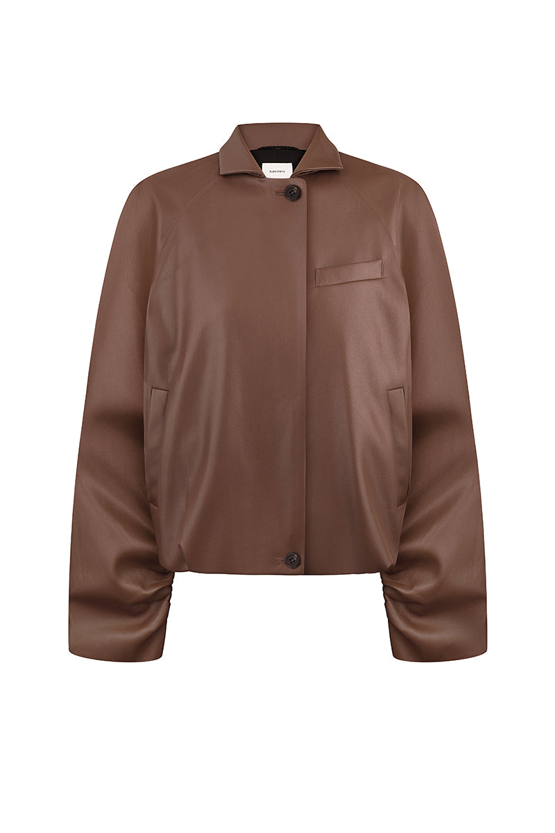 Brown bomber jacket in fox leather by ELENAREVA, shown in a close-up image highlighting the textured leather material and stylish design.