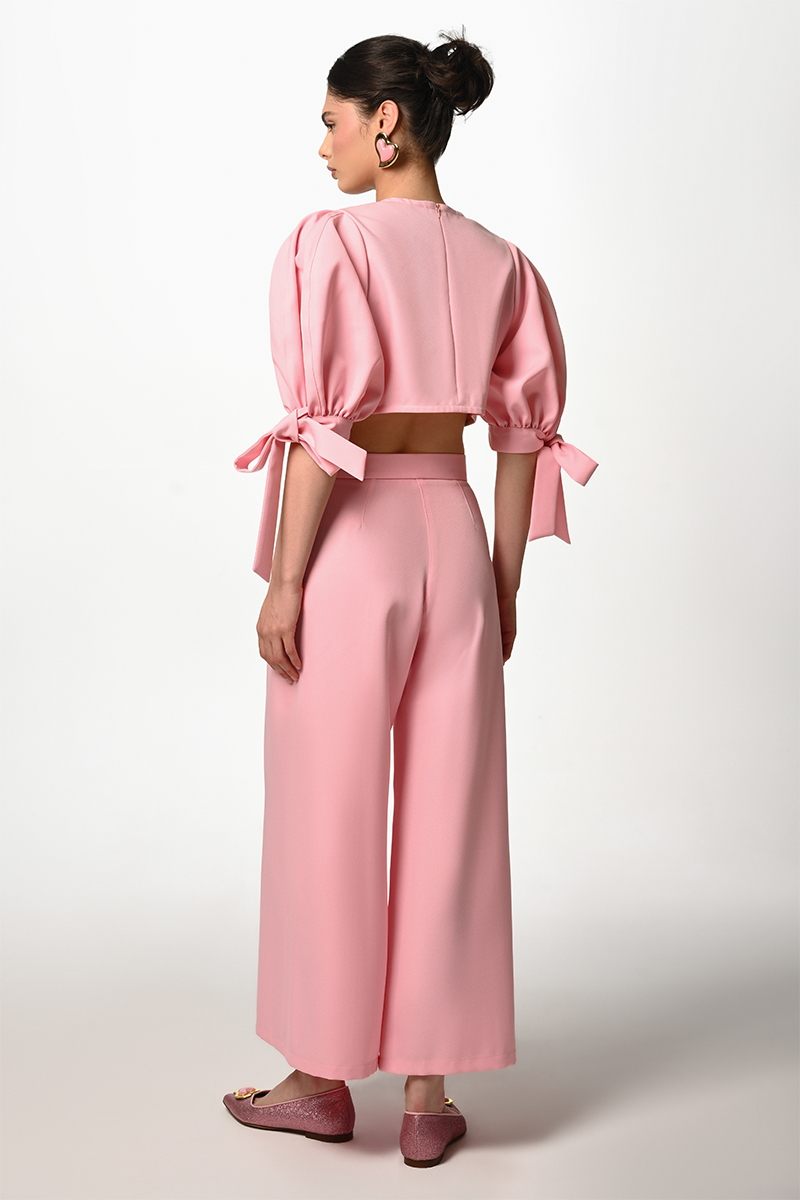 Liya pink bubble bow top, stylish women's fashion top with puffed sleeves and decorative bow detail on the front.