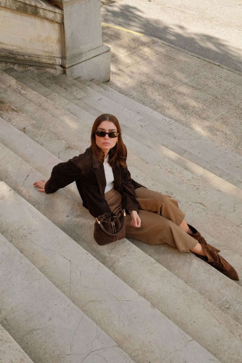 Saonara chocolate suede bucket shoulder bag with rounded shape and adjustable strap, stylish and versatile accessory.
