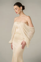 Gold silk taffeta and chiffon gown by I.H.F featuring a burstier mermaid style with off-shoulder and bishop sleeves.