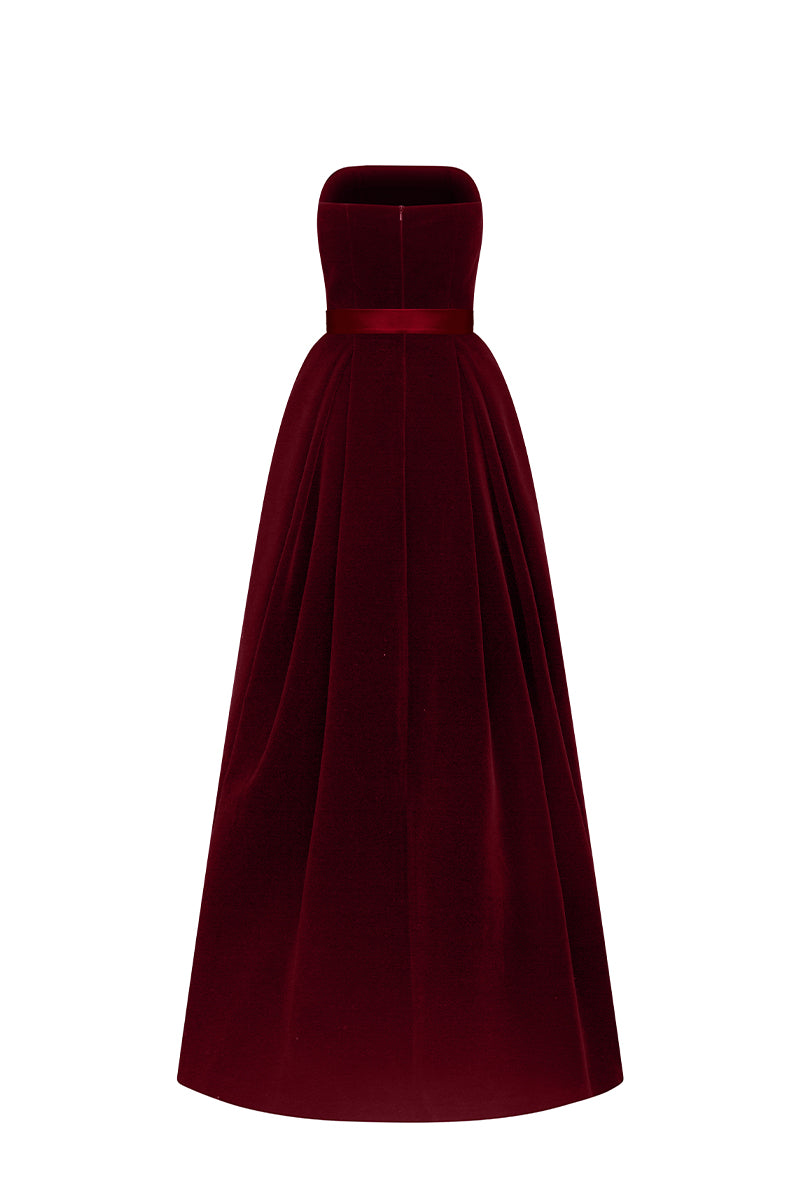 Pink velvet LYLA LYON gown by I.H.F with burstier pleats and A-line silhouette, showcased on a model in a stylish setting.