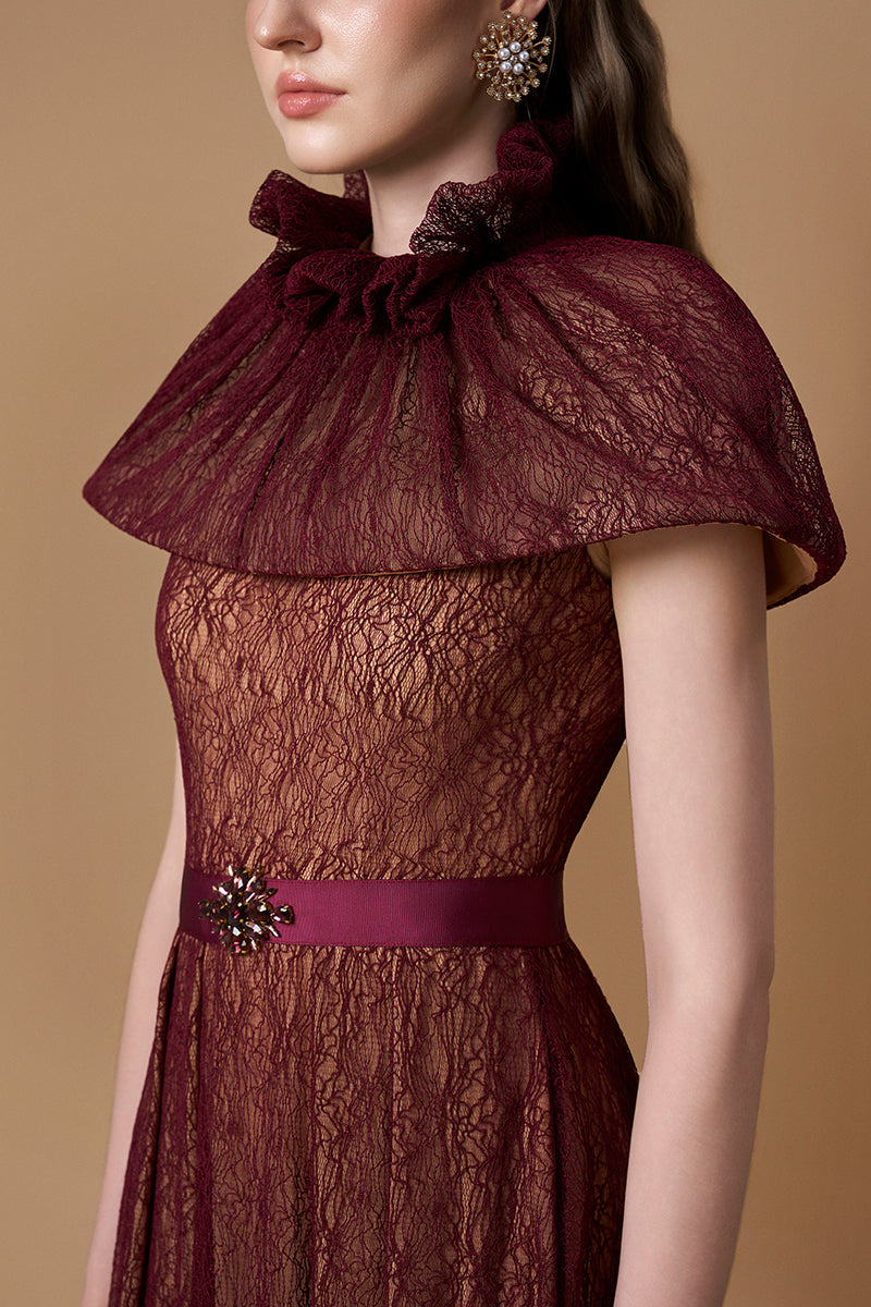 Elegant Bordeaux lace gown by I.H.F featuring a bustier, A-line silhouette, and mini cape with intricate guipure lace details.