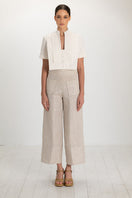 Light beige button pants from ANA + MARIA featuring a high waist and classic button closure, styled for casual wear.
