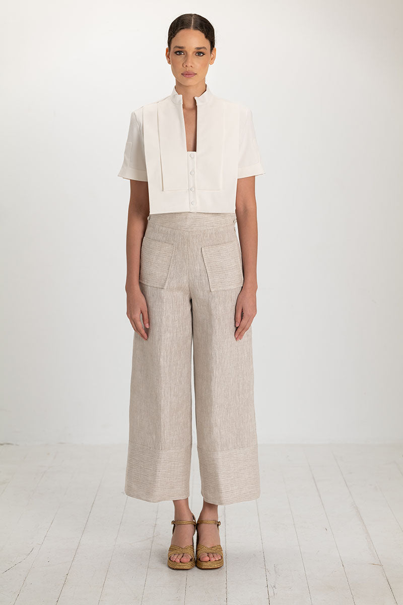 Light beige button pants from ANA + MARIA featuring a high waist and classic button closure, styled for casual wear.