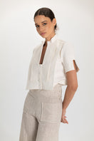 Tan button pants by ANA + MARIA displayed on a model, showcasing the relaxed fit and stylish design.