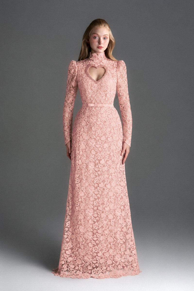 Light pink floral lace gown by I.H.F Studio featuring long sleeves, a heart cutout, and a flowing maxi dress design.